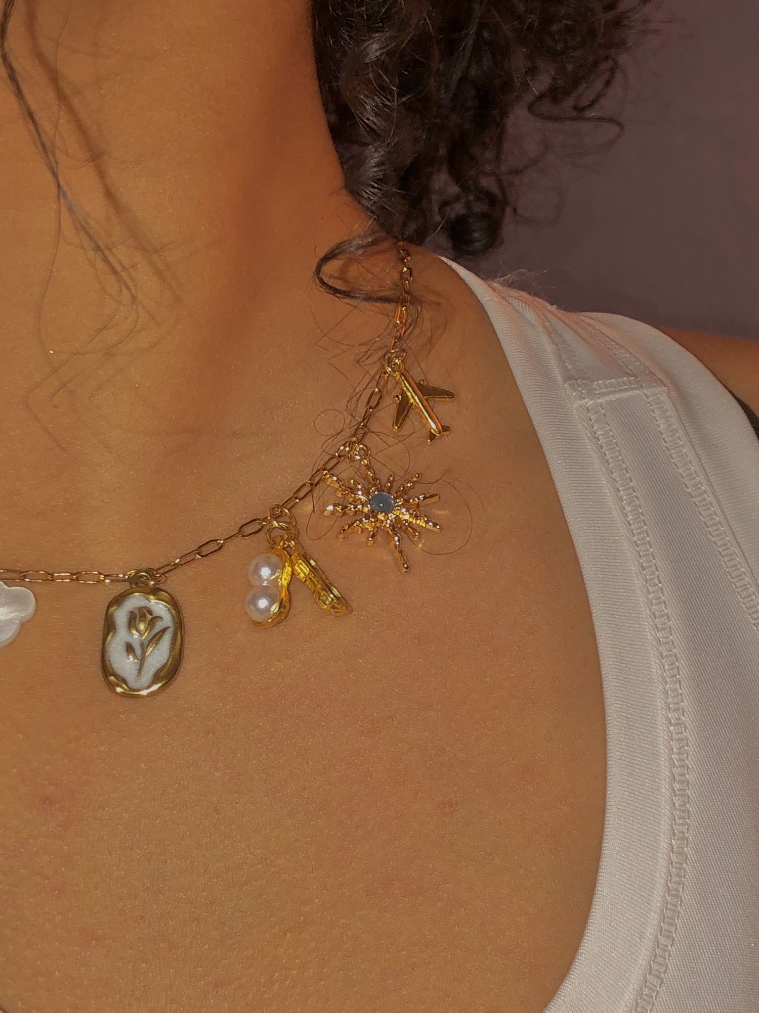 A Gilded Bond charm bar NYC permanent jewelry